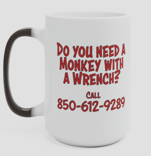 11oz coffee cup white with a black handle and the with the words do you need a monkey with a wrench in red also has phone number below